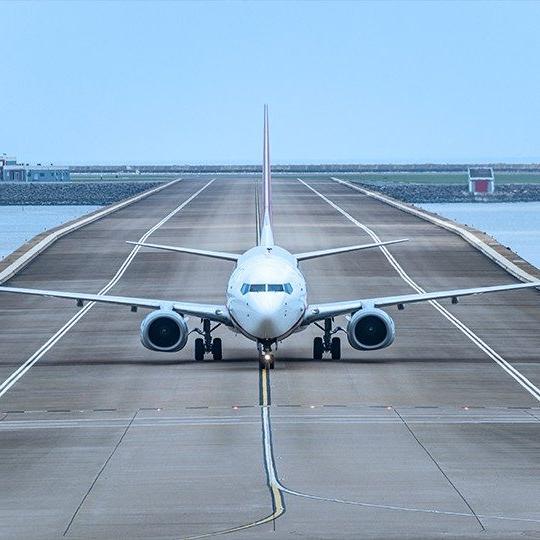 View of the front of a commercial airplane coming down the runway